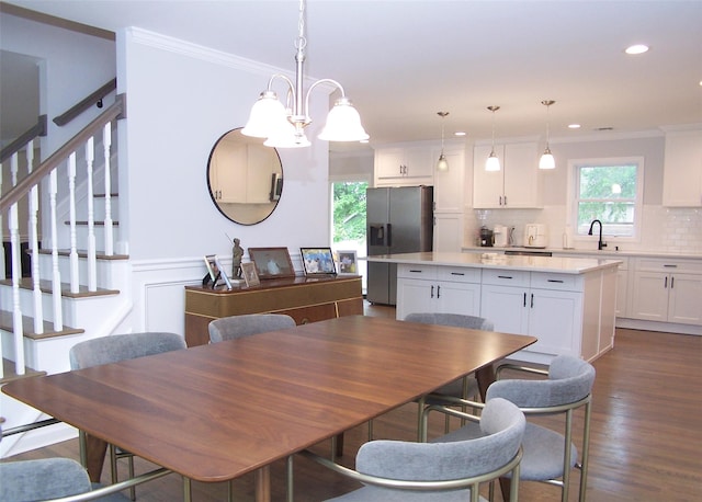 8 W Narcissus Rd, Mastic Beach, NY 11951 - dining room with ornamental molding, dark wood-style floors, recessed lighting, and stairs