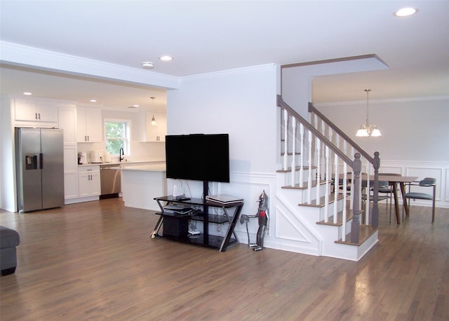 8 W Narcissus Rd, Mastic Beach, NY 11951 - living area featuring ornamental molding, a chandelier, a decorative wall, a wainscoted wall, and recessed lighting