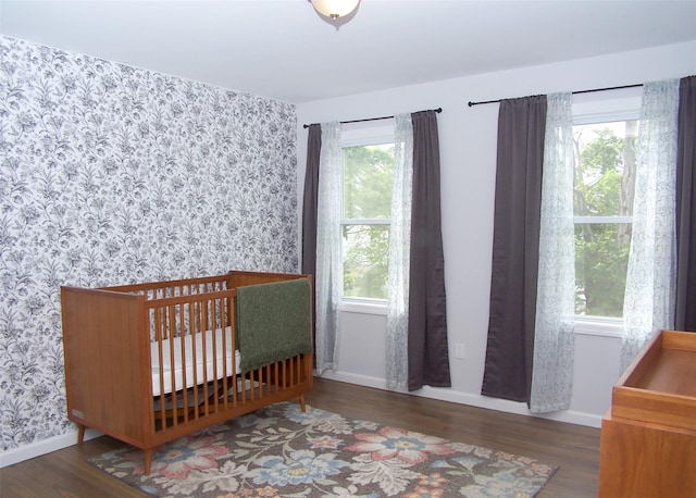 8 W Narcissus Rd, Mastic Beach, NY 11951 - bedroom featuring wallpapered walls and wood finished floors