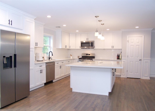 8 W Narcissus Rd, Mastic Beach, NY 11951 - kitchen with stainless steel appliances, crown molding, white cabinets, tasteful backsplash, and recessed lighting