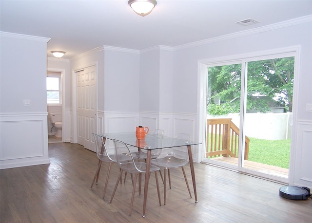 8 W Narcissus Rd, Mastic Beach, NY 11951 - dining space with healthy amount of natural light, wood finished floors, ornamental molding, wainscoting, and a decorative wall