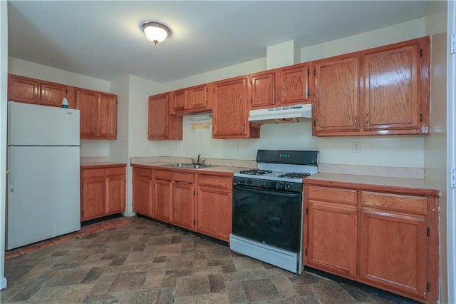 117 Bethune Blvd Unit 3, Spring Valley, NY 10977 - kitchen featuring freestanding refrigerator, range with gas stovetop, under cabinet range hood, light countertops, and stone finish floors