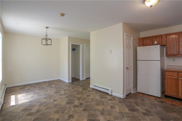 117 Bethune Blvd Unit 3, Spring Valley, NY 10977 - kitchen with freestanding refrigerator, a baseboard radiator, stone finish floors, and brown cabinetry