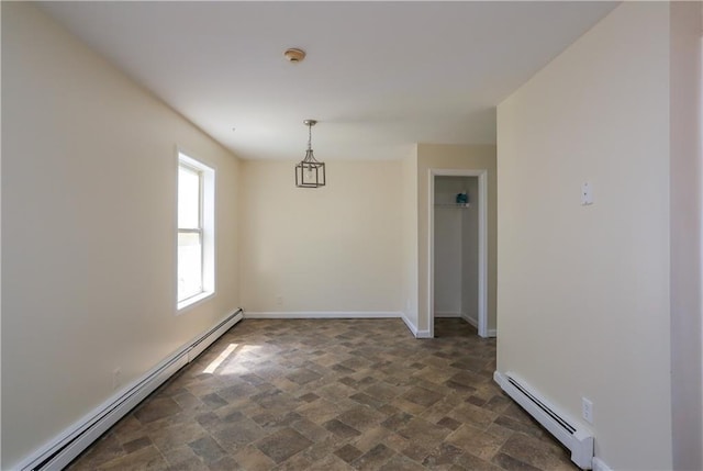 117 Bethune Blvd Unit 3, Spring Valley, NY 10977 - spare room with a baseboard heating unit, a smoke detector, and dark stone finish floors