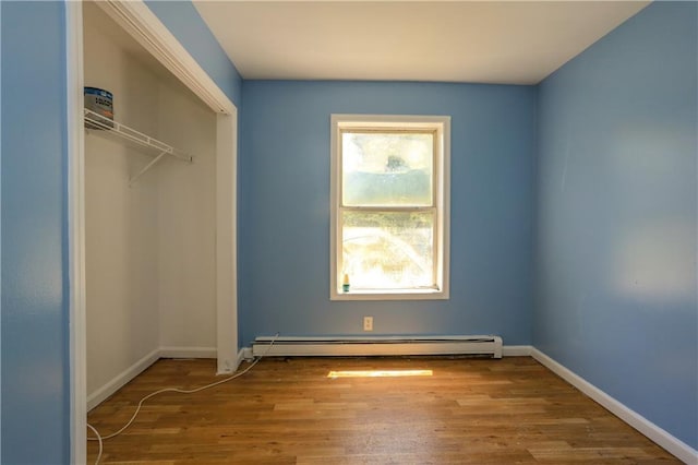 117 Bethune Blvd Unit 3, Spring Valley, NY 10977 - unfurnished bedroom with a baseboard heating unit, wood finished floors, and a closet