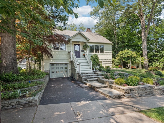 347 Scudder Ave, Northport, NY 11768 - view of front facade featuring asphalt driveway, a chimney, and a garage