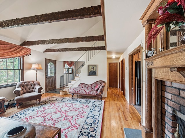 347 Scudder Ave, Northport, NY 11768 - living area with a fireplace, light wood-style flooring, stairway, baseboard heating, and a baseboard heating unit