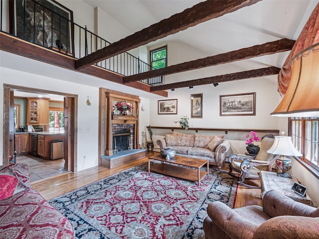 347 Scudder Ave, Northport, NY 11768 - living area with light wood-type flooring, beamed ceiling, a fireplace with raised hearth, and high vaulted ceiling