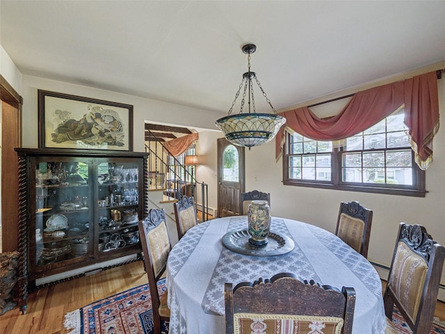 347 Scudder Ave, Northport, NY 11768 - dining space featuring stairs, wood finished floors, and baseboard heating