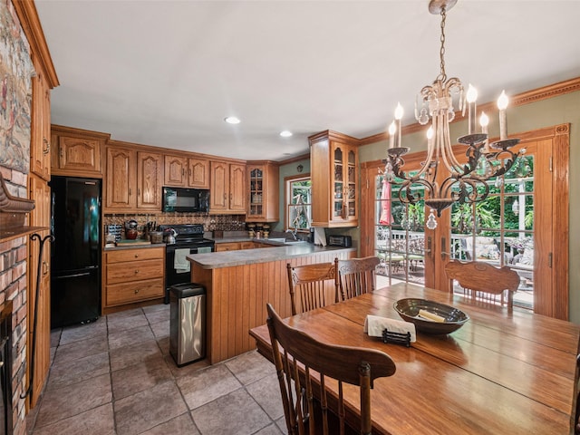 347 Scudder Ave, Northport, NY 11768 - kitchen with black appliances, a chandelier, healthy amount of natural light, a peninsula, and crown molding