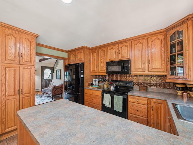 347 Scudder Ave, Northport, NY 11768 - kitchen featuring black appliances, tasteful backsplash, glass insert cabinets, and brown cabinets