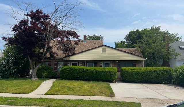 9 Hunt Ln, Levittown, NY 11756 - view of front of property with a front yard and a chimney