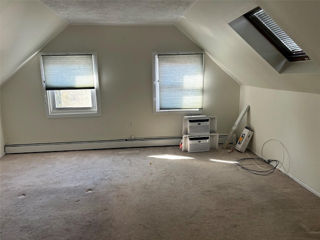9 Hunt Ln, Levittown, NY 11756 - additional living space featuring vaulted ceiling, carpet flooring, a baseboard radiator, and a textured ceiling