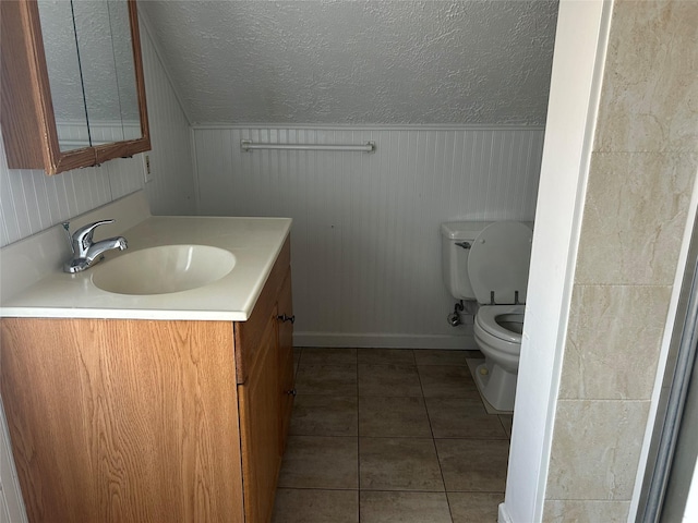 9 Hunt Ln, Levittown, NY 11756 - half bathroom featuring vanity, toilet, tile patterned flooring, baseboards, and a textured ceiling
