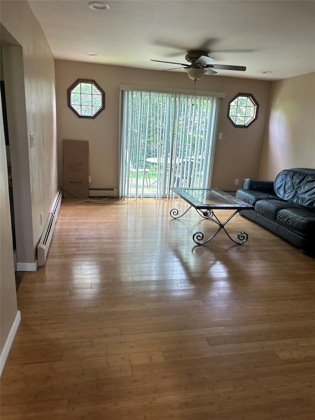 9 Hunt Ln, Levittown, NY 11756 - unfurnished living room with ceiling fan, a baseboard heating unit, light wood finished floors, baseboards, and recessed lighting