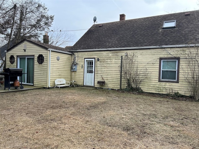 9 Hunt Ln, Levittown, NY 11756 - rear view of house featuring a chimney, roof with shingles, and a yard