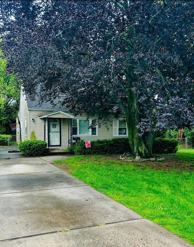 113 Edgeworth St, Valley Stream, NY 11581 - view of property hidden behind natural elements with a front yard and a shingled roof
