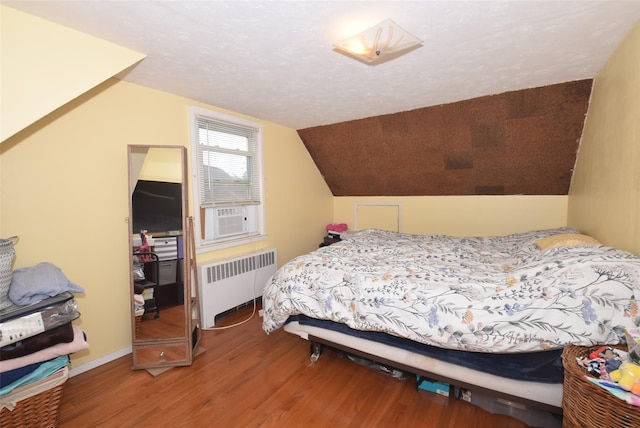 113 Edgeworth St, Valley Stream, NY 11581 - bedroom with radiator heating unit, wood finished floors, cooling unit, and vaulted ceiling