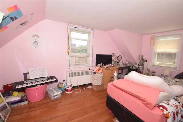 113 Edgeworth St, Valley Stream, NY 11581 - bedroom featuring radiator, wood finished floors, vaulted ceiling, and cooling unit