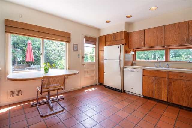 3 Little Ln, White Plains, NY 10605 - kitchen with white appliances, light countertops, brown cabinets, recessed lighting, and light tile patterned floors