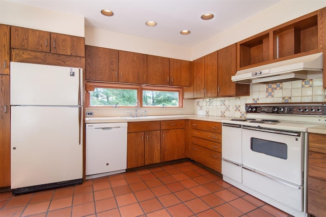 3 Little Ln, White Plains, NY 10605 - kitchen featuring white appliances, under cabinet range hood, light countertops, decorative backsplash, and brown cabinets