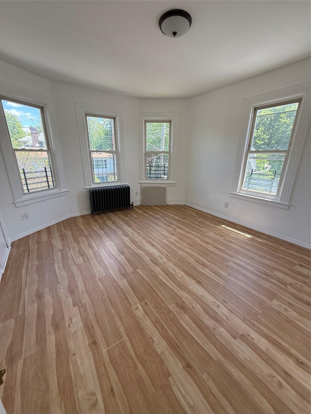 8520 85th Rd, Woodhaven, NY 11421 - spare room with radiator, light wood-style floors, and baseboards