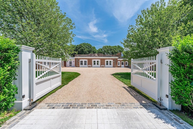 1750 Mount Beulah Ave, Southold, NY 11971 - view of front of house with a gate, french doors, and driveway
