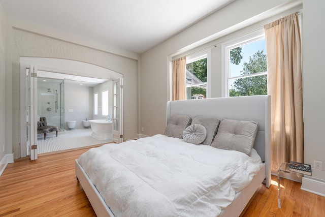 1750 Mount Beulah Ave, Southold, NY 11971 - bedroom featuring light wood finished floors, multiple windows, and ensuite bath