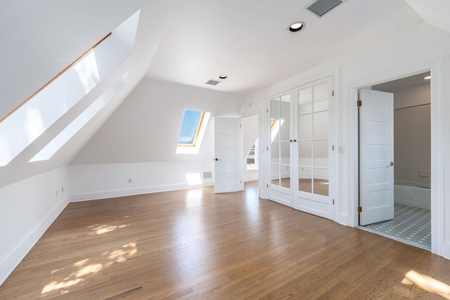 1750 Mount Beulah Ave, Southold, NY 11971 - additional living space featuring a skylight, vaulted ceiling, wood finished floors, french doors, and recessed lighting