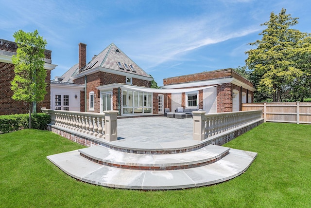 1750 Mount Beulah Ave, Southold, NY 11971 - rear view of property with brick siding, a patio area, and a chimney