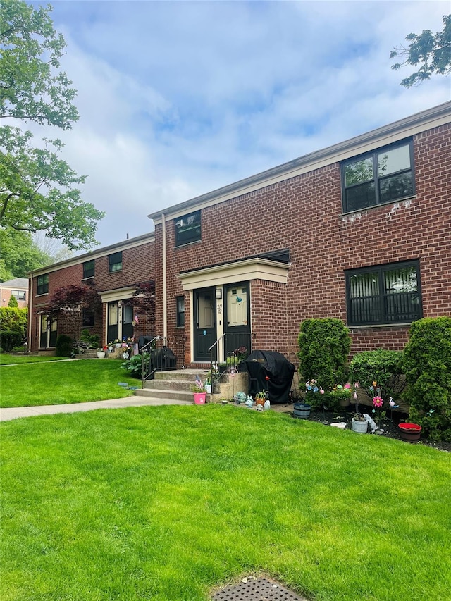 219-02 75th Ave Unit 2F, Oakland Gardens, NY 11364 - townhome / multi-family property featuring brick siding and a front lawn