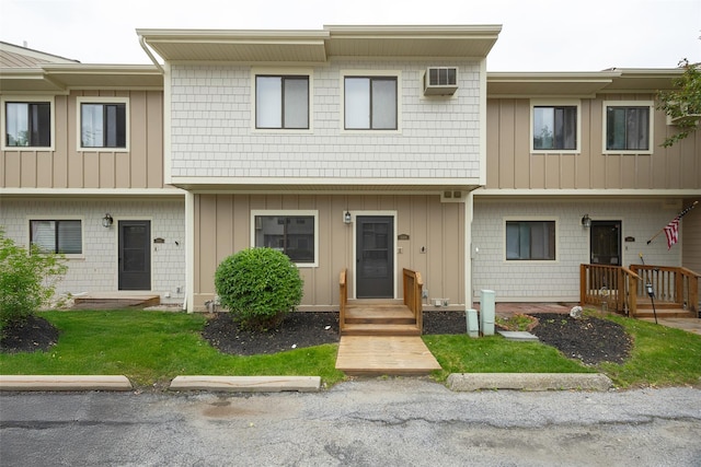 5306 Chelsea Cv N, Hopewell Junction, NY 12533 - view of property with a wall unit AC, board and batten siding, and uncovered parking