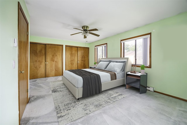 5306 Chelsea Cv N, Hopewell Junction, NY 12533 - bedroom featuring light colored carpet, baseboard heating, multiple closets, and ceiling fan