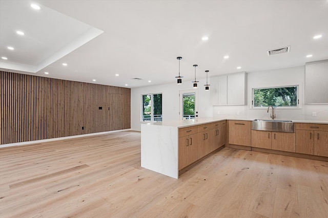 8 Junard Dr, Roslyn, NY 11576 - kitchen with recessed lighting, a peninsula, light wood finished floors, and light countertops