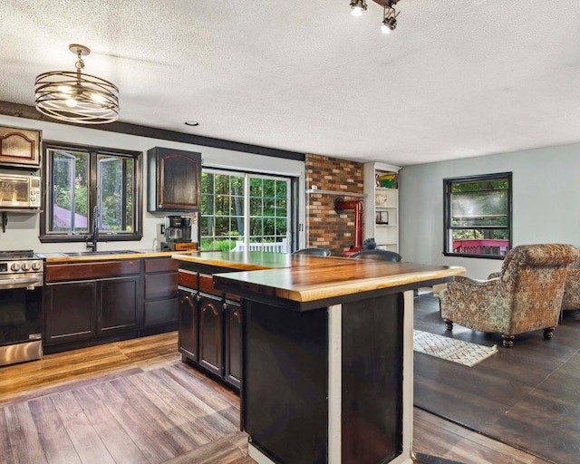 12 Summit Dr, Eldred, NY 12792 - kitchen with appliances with stainless steel finishes, a textured ceiling, wood finished floors, wood counters, and hanging light fixtures