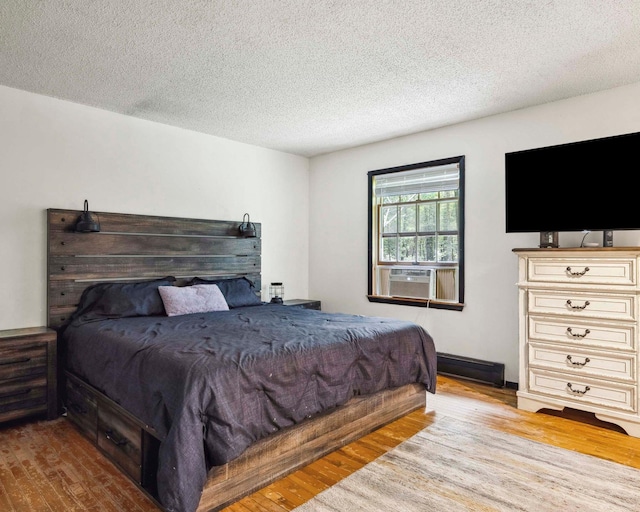 12 Summit Dr, Eldred, NY 12792 - bedroom with cooling unit, wood finished floors, and a textured ceiling