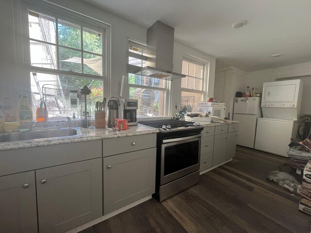 130 Van Dyke St, Brooklyn, NY 11231 - kitchen with island range hood, white appliances, a sink, dark wood-type flooring, and stacked washer / drying machine