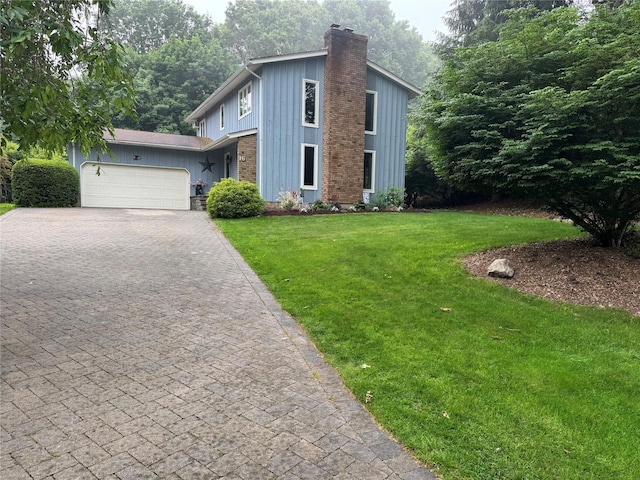 16 Short Way, Shoreham, NY 11786 - view of front of home with a chimney, board and batten siding, a front lawn, an attached garage, and driveway