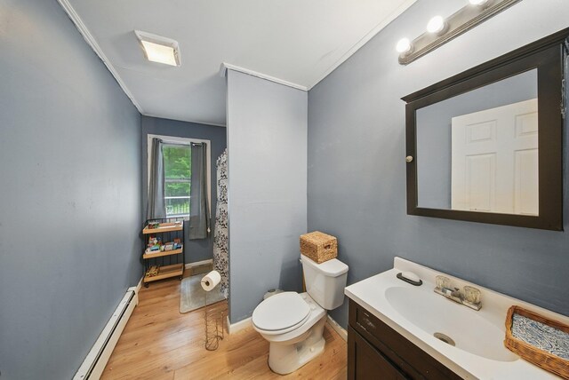 346 Stone School House Rd, Bloomingburg, NY 12721 - bathroom featuring a baseboard heating unit, vanity, wood finished floors, and ornamental molding