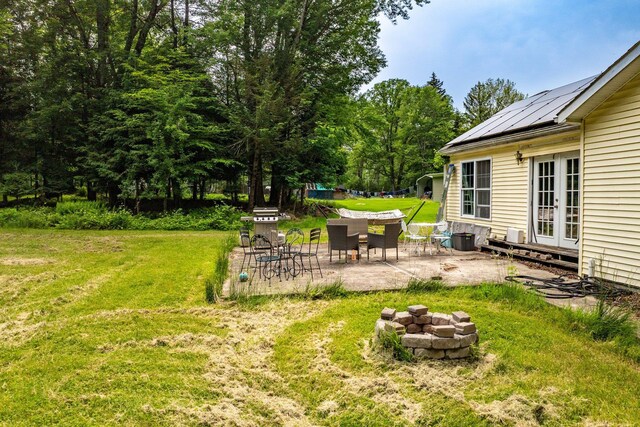 346 Stone School House Rd, Bloomingburg, NY 12721 - view of green lawn featuring french doors, a patio, and an outdoor fire pit