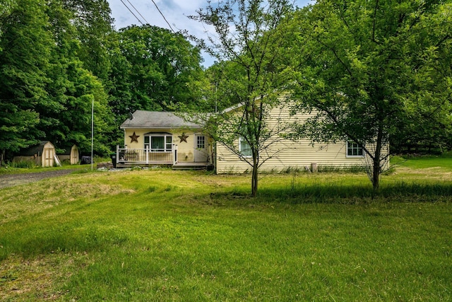 346 Stone School House Rd, Bloomingburg, NY 12721 - view of front of house featuring a storage shed, a wooden deck, and a front lawn