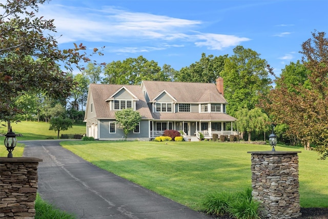 6 Long Meadow Way, Goshen, NY 10924 - view of front of property with a porch, a chimney, and a front lawn