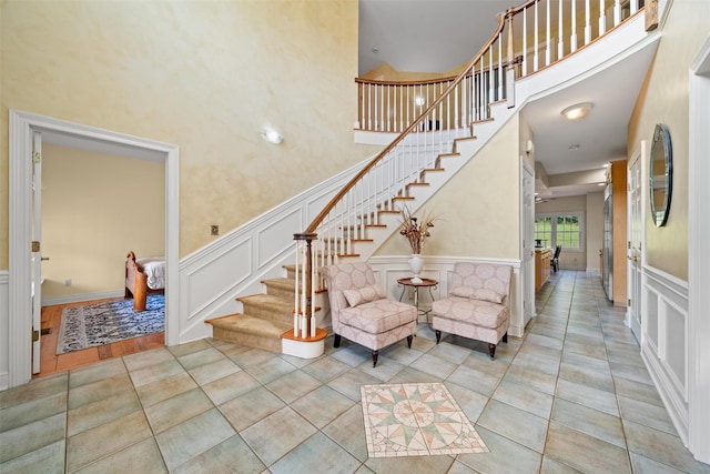 6 Long Meadow Way, Goshen, NY 10924 - tiled entrance foyer with a decorative wall, stairway, a wainscoted wall, and a towering ceiling