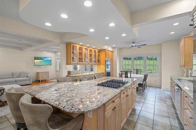6 Long Meadow Way, Goshen, NY 10924 - kitchen with appliances with stainless steel finishes, light stone countertops, glass insert cabinets, a kitchen island, and recessed lighting