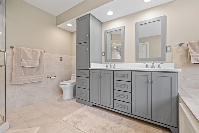 6 Long Meadow Way, Goshen, NY 10924 - bathroom featuring double vanity, tile walls, a shower stall, and recessed lighting