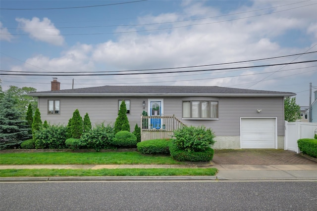 12 Roosevelt Pl, Massapequa, NY 11758 - single story home featuring decorative driveway, a garage, and a chimney