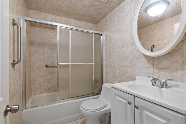 12 Roosevelt Pl, Massapequa, NY 11758 - bathroom with tile walls, vanity, toilet, and shower / bath combination with glass door