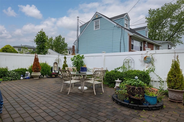 12 Roosevelt Pl, Massapequa, NY 11758 - fenced backyard featuring a patio area and outdoor dining space