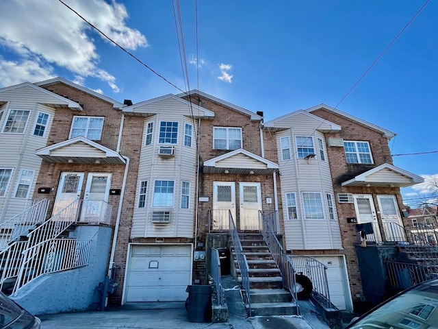 132-06 57th Rd, Flushing, NY 11355 - townhome / multi-family property featuring a garage, brick siding, and driveway