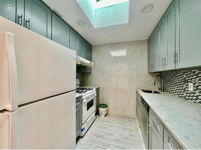 132-06 57th Rd, Flushing, NY 11355 - kitchen with white appliances, a sink, under cabinet range hood, a skylight, and green cabinetry
